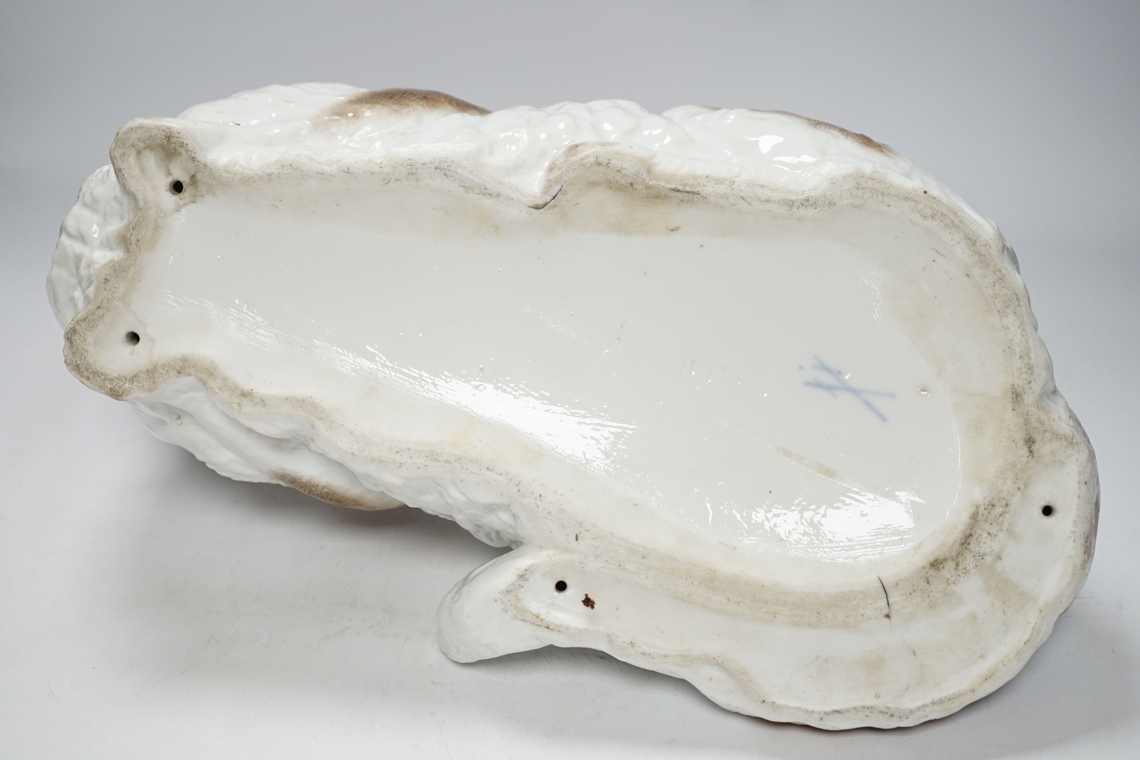 A large Meissen style figure of a seated cat, pseudo crossed swords mark to the base, 37cm wide